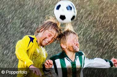 children heading a football