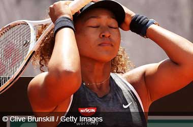 Naomi Osaka looking upset after a defeat