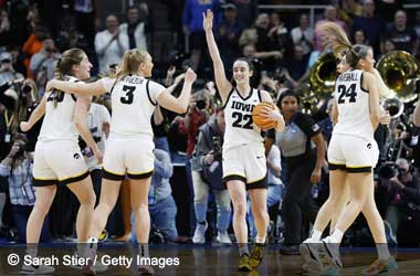 Caitlin Clark celebrates with her Iowa Hawkeyes teammates after beating LSU Tigers in Elite 8 Round 2024